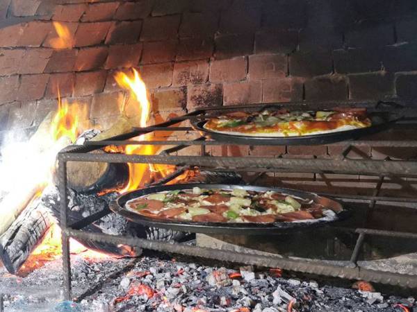 Piza yang siap dibentuk dimasak di dalam ketuhar tanah liat dengan suhu 300 darjah celsius selama kira-kira lima minit.