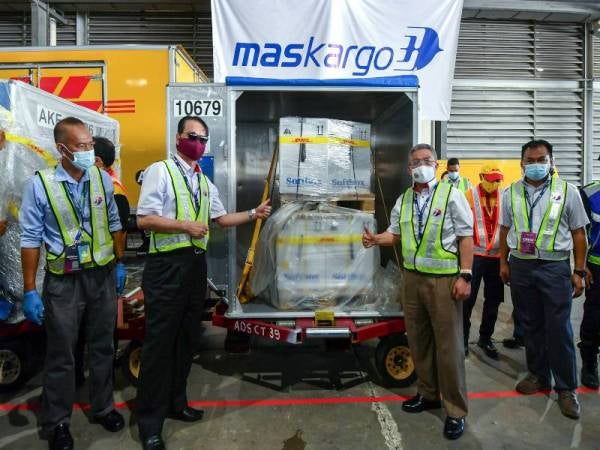 Dr Adham dan Dr Noor Hisham menunjukkan kotak berisi vaksin Covid-19 jenis Pfizer-BioNTech sejurus vaksin tersebut tiba di Advanced Cargo Centre (ACC), Lapangan Terbang Antarabangsa Kuala Lumpur (KLIA) hari ini. - Foto Bernama