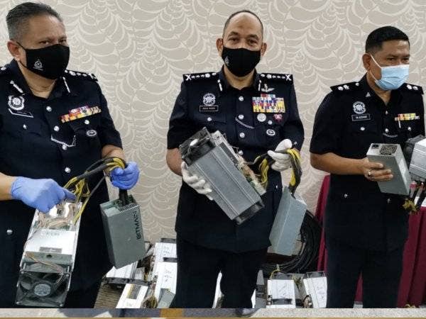 Mior Faridalathrash (tengah) bersama timbalannya, Datuk Mazlan Santarai (kiri) menunjukkan mesin bitcoin yang dirampas dalam serbuan Op Bersepadu Bitcoin di Tapah pada sidang akhbar di Ibu Pejabat Polis Kontinjen (IPK) Perak, Ipoh pada Jumaat.