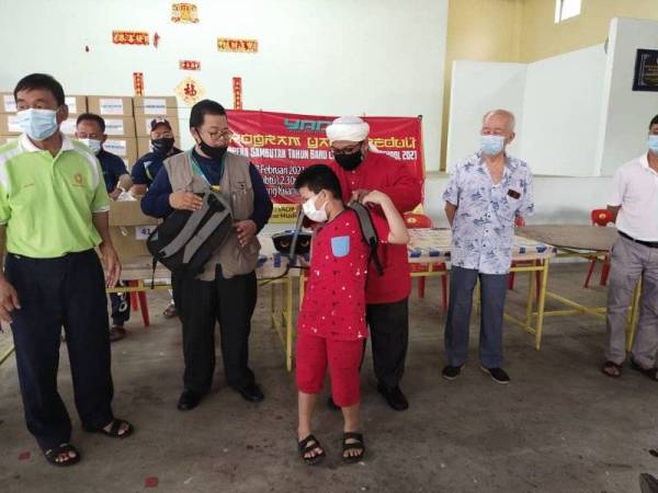 Nasrudin menyerahkan bantuan peralatan persekolahan kepada murid dalam kalangan kaum Tionghua sekitar Gambang pada Sabtu.