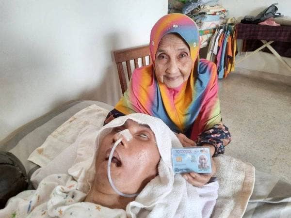 Zainun menunjukkan Mykad milik Azman di rumahnya di Lorong 12, Kubang Buaya pada Rabu.