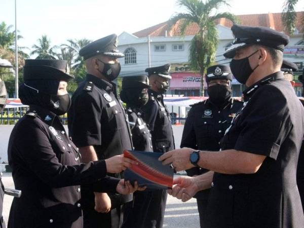 Mior Faridalathrash (kanan) menyampaikan sijil penghargaan kepada Inspektor Nurul Shafinaz Halim (dua, kiri) pada majlis Lawatan Ketua Polis Perak dan Perhimpunan Bulanan Ketua Polis Perak di pekarangan IPD Kerian hari ini. - Foto Bernama