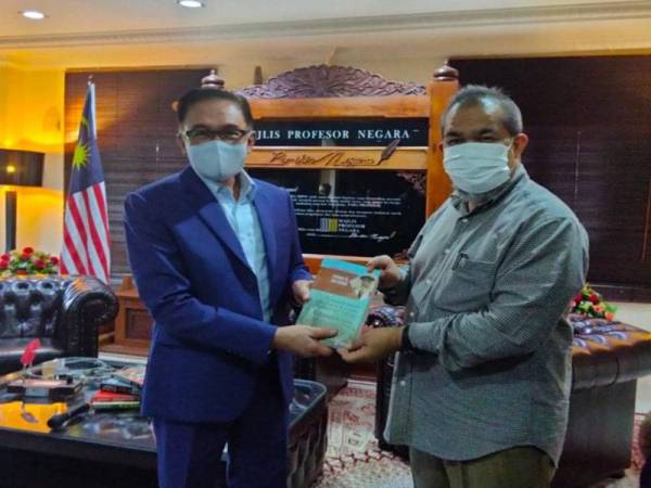Anwar turut menerima sebuah buku daripada Pensyarah Fakulti Ekologi Manusia, Universiti Putra Malaysia (UPM), Profesor Dr Zaid Ahmad yang turut hadir pada program berkenaan sebagai cenderahati.