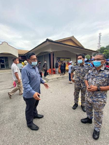 Syahrul Nizam (kiri) ketika berbincang sesuatu dengan anggota penguat kuasa MPJL.