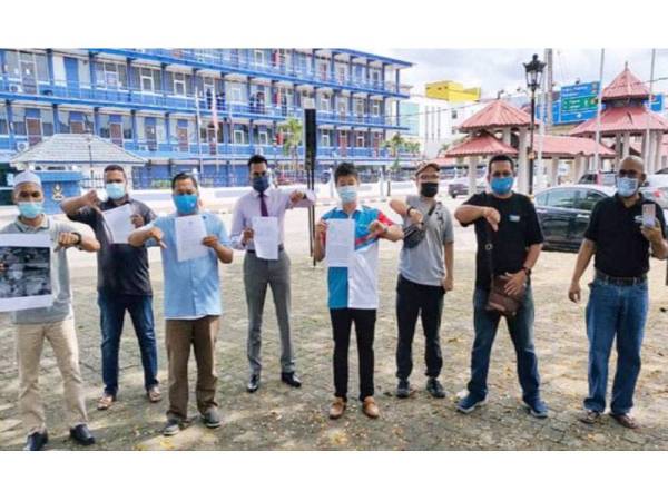 Mohd Mustaqim (tiga dari kiri) menunjukkan dua laporan polis yang dibuat di IPD Kuantan pada Jumaat.