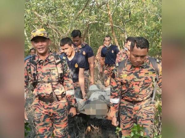 Anggota bomba mengusung mangsa keluar dari kawasan paya bakau Kampung Air Tawar Baru, di sini, petang Jumaat.