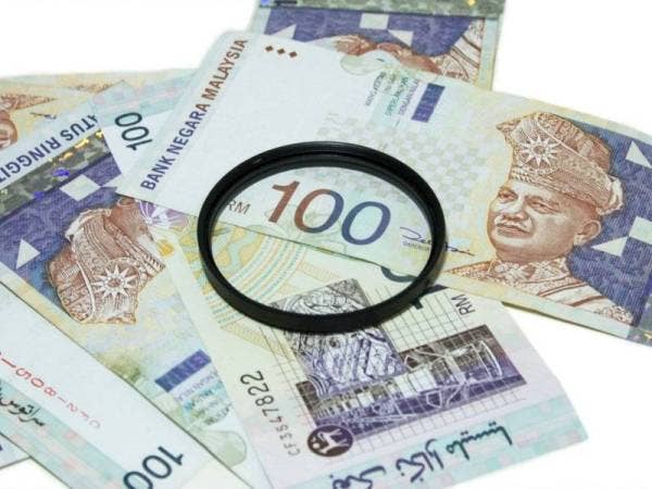 Seorang wanita ditahan selepas didakwa menggunakan wang palsu. (Gambar hiasan - Foto 123RF)