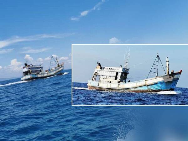 Bot nelayan asing bersama empat kru yang cuba meloloskan diri sebelum berjaya ditahan - Foto Jabatan Perikanan Johor