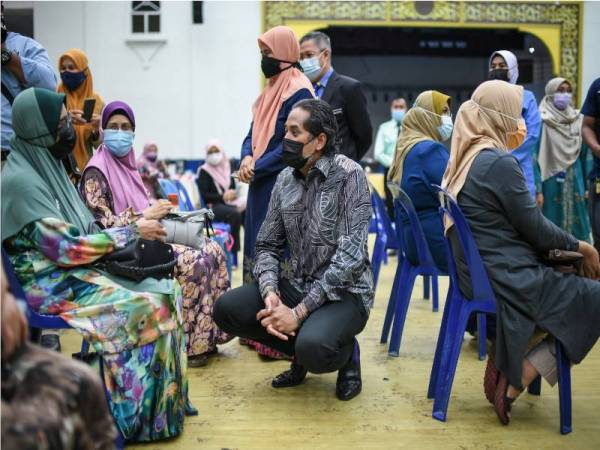 Khairy Jamaluddin beramah mesra dengan para penerima suntikan vaksin ketika melawat ke Pusat Pemberian Vaksin di Dewan Wawasan 2020, pada Selasa.  - Foto: Bernama (2021) Hak Cipta Terpelihara
