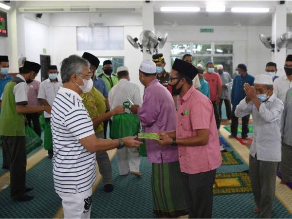 Al-Sultan Abdullah berkenan menyampaikan sumbangan ketika mencemar duli berangkat ke Program Santuni Kasih dan Kurniaan Daerah Pekan di Masjid Kampung Batu, Pekan pada Rabu. - Foto Bernama