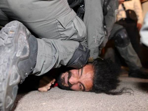 Seorang penunjuk perasaan Palestin ditangkap oleh anggota keselamatan Israel dalam tunjuk perasaan membantah pengusiran keluarga Palestin di Sheikh Jarrah, Baitulmaqdis Timur baru-baru ini. - AFP