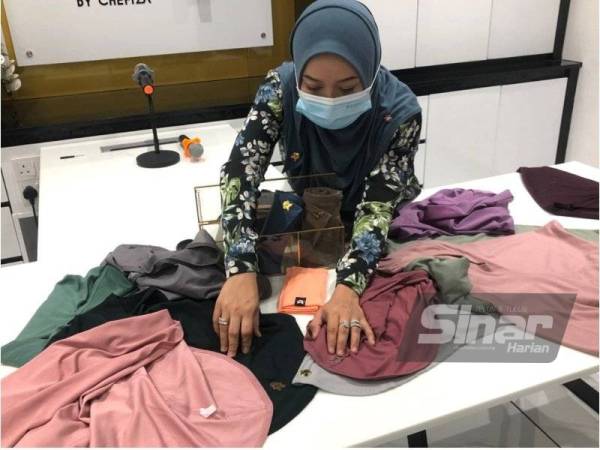 Che Nurul Hafizah menunjukkan logo Cap Dagangan Syarikat By Che Fiza yang diciplak.