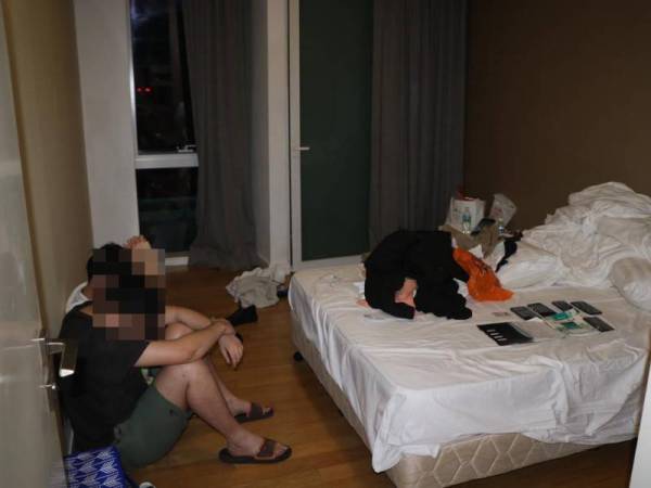 Antara individu yang ditahan dalam serbuan di sebuah kondominium di Jalan Sultan Ismail, Kuala Lumpur pada Sabtu.