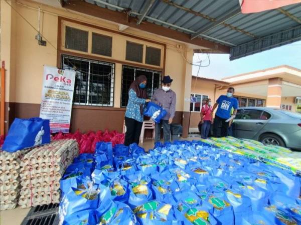 Tajuddin menyerahkan sumbangan Bantuan Rakyat Prihatin kepada Pegawai Perubatan Klinik Kesihatan Langkap, Dr Noor Farhanah Tauhid Ahmad.