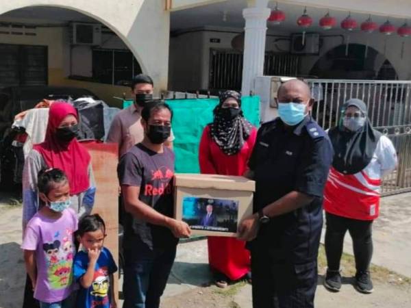 Hanyan menyerahkan sumbangan kepada penjaja rojak di kediamannya di Chukai, Kemaman - Foto ihsan IPD Kemaman