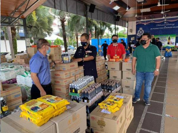 Abdullah (dua dari kiri) melihat sumbangan yang disampaikan wakil tujuh syarikat di Kota Bharu pada Khamis.