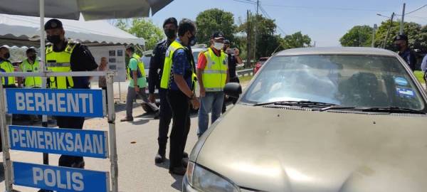 Rohaimi (kiri) meninjau pelaksanaan Perintah Kawalan Pergerakan Diperketatkan (PKPD) di Mukim Kuala Dungun,Dungun, pada Rabu.
