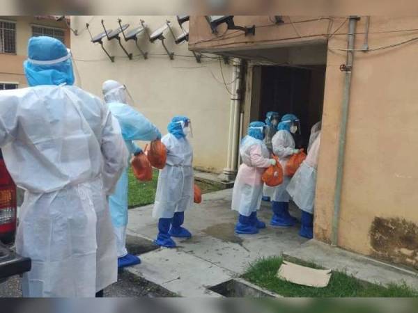 Penduduk Flat Taman Waja menerima sumbangan Pusat Khidmat Ahli Parlimen Kuala Pilah yang diagihkan oleh anggota APM daerah Kuala Pilah Khamis lepas. - Foto Pejabat Kesihatan Kuala Pilah