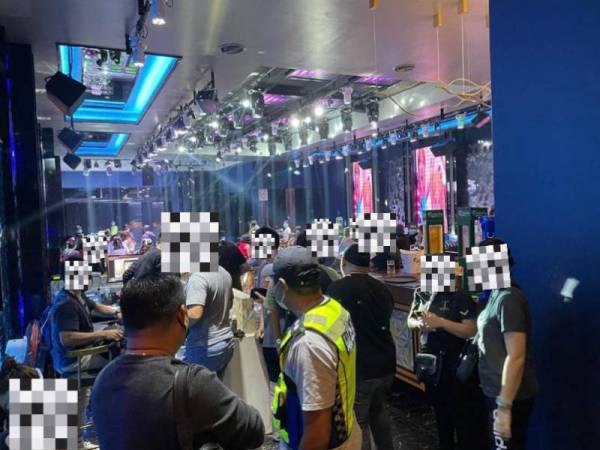 Antara individu yang ditahan di sebuah pusat hiburan di Waterfront Jalan Tun Fuad Stephen, Kota Kinabalu pada Ahad.