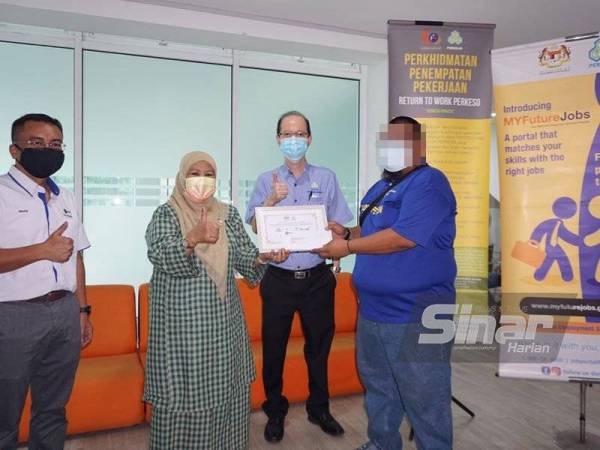 Zaiton Ismail (dua dari kiri) memberi galakan kepada golongan gelandangan yang menghadiri sesi temuduga bagi mendapatkan pekerjaan di Anjung Singgah, Johor Bahru, pada Isnin.