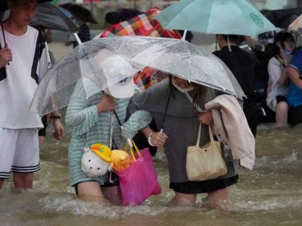 Kehidupan masyarakat tempatan beransur pulih sambil kerja-kerja nyahjangkit turut dilaksanakan.- Foto The Guardian