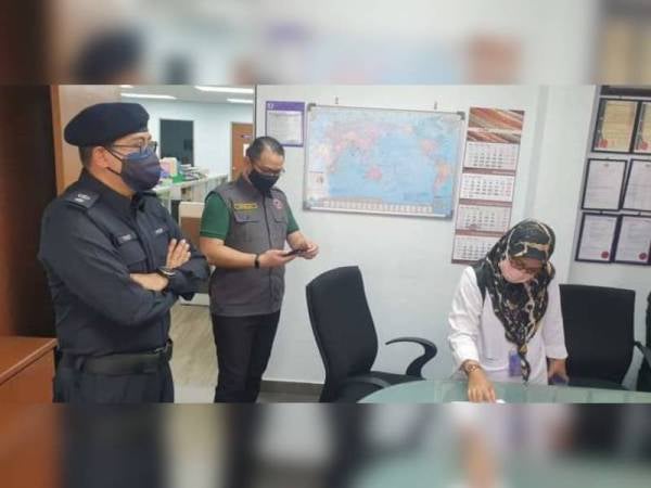 Roslin (tengah) semasa membuat pemeriksaan di sebuah kilang di Nilai pada Ops Pematuhan SOP pada Jumaat.