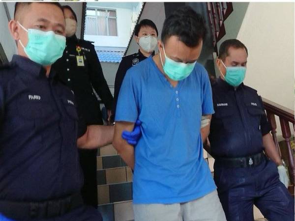 Tertuduh ketika dibawa keluar dari Mahkamah Sesyen di sini, pada Jumaat.