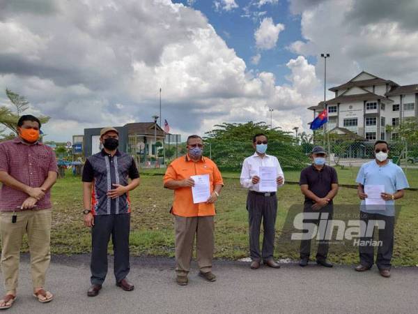 Aminolhuda (tiga dari kiri) menunjukkan salinan laporan SPRM menuntut Perdana Menteri disiasat kerana membuat tawaran kepada ahli Parlimen pembangkang di Ibu Pejabat SPRM Johor, Johor Bahru pada Ahad.