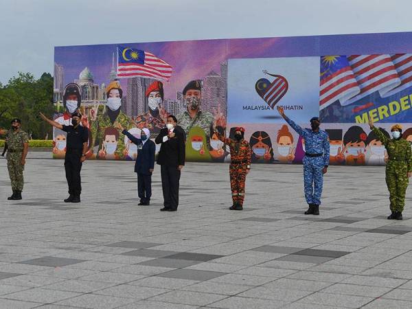 Pembaca Ikrar Rukun Negara, Penguasa Kanan Bomba II Siti Farizun Naim, 33, (tiga, kanan) pada raptai sambutan Hari Kebangsaan dan Hari Malaysia 2021 ketika tinjauan Bernama di Dataran Pahlawan hari ini.