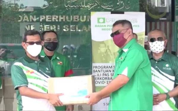 Ahmad Yunus (kiri) menyerahkan sumbangan kepada wakil 22 kawasan Pas di Selangor.