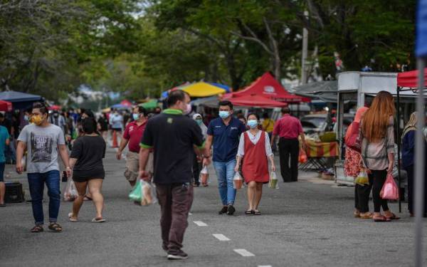 Orang ramai yang lengkap suntikan dos vaksin dilihat mengambil peluang untuk membeli makanan asas ketika tinjauan Foto Bernama di tapak pasar malam Taman Jaya hari ini.