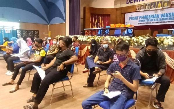 PPV Dewan Sri Tunjong, Kota Bharu dipenuhi pelajar sekolah untuk mendapatkan suntikan dos pertama vaksin pada Isnin.
