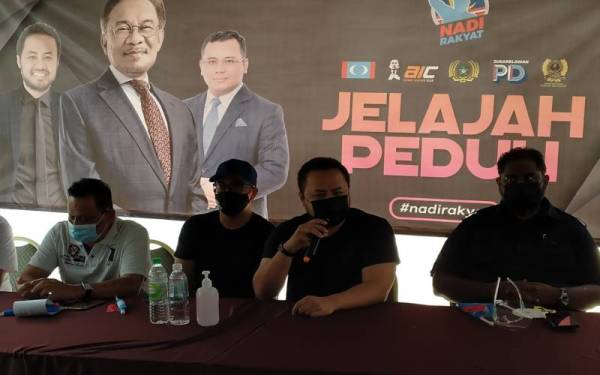 Farhash Wafa Salvador (dua kanan) menyampaikan ucapan pada Program Jelajah Peduli yang turut dihadiri Tinagaran (kanan) di perkarangan Pejabat PKR Perak, di sini pada Sabtu.