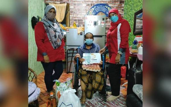 Sazali menerima sumbangan barang keperluan dapur dan wang tunai daripada pertubuhan bukan kerajaan (NGO) Permata di rumahnya di Flat Taman Cendana, Pasir Gudang, pada Rabu.