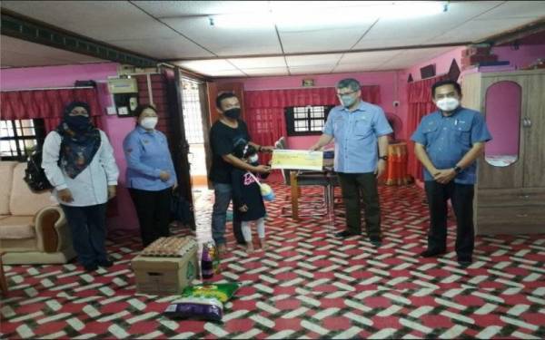 Othman menyampaikan replika cek faedah pengurusan mayat kepada Darwis di kediaman mereka di Kampung Pisang, Cherok To' Kun Atas, Bukit Mertajam pada Rabu.