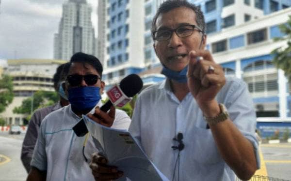 Faizan Mohd Nor (kanan) selepas membuat laporan di Ibu Pejabat Polis Daerah (IPD) Dang Wangi pada Isnin.