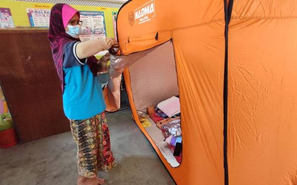 Habsah Mohd Med, 58, mengemas khemah yang didudukinya di PPS Sekolah Kebangsaan (SK) Convent, Alor Setar pada Khamis.