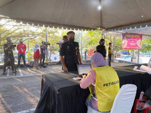 Ready to vote! A police personnel checking his details prior to casting his ballot. 