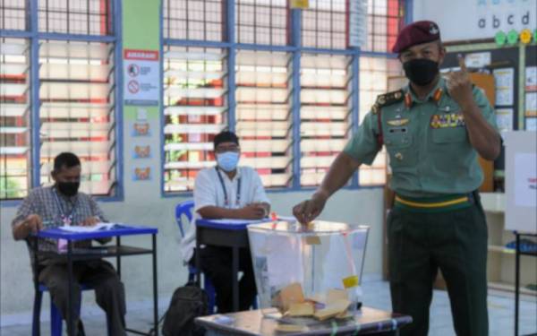Panglima 3 Divisyen Infantri Mejar Jeneral Datuk Tengku Muhammad Fauzi Tengku Ibrahim (kanan) mengundi pada proses pengundian awal bagi PRN Melaka di Sekolah Kebangsaan Kem Terendak II pada Selasa. - Foto Bernama