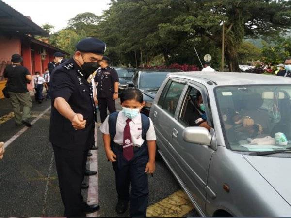 Noorzainy melihat ibu bapa yang menghantar anak mereka ke sekolah sempena Program Pemantauan SOP Covid-19 Bersama Pengurusan SK Cator Avenue dan Program Back To School di Ipoh pada Isnin.