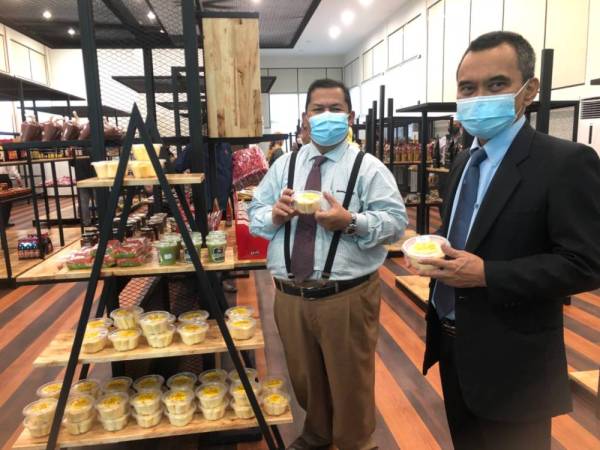 Ab Aziz (dua dari kanan) menunjukkan produk makanan iaitu tapai ubi kayu yang dihasilkan oleh usahawan tempatan di KALA Sentral di Dataran Muhammadi, Kota Bharu pada Isnin.