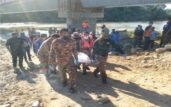 Pasukan penyelamat membawa mangsa yang berjaya ditemui pada hari ketiga SAR untuk diserahkan kepada polis. - Foto ihsan Bomba Perak