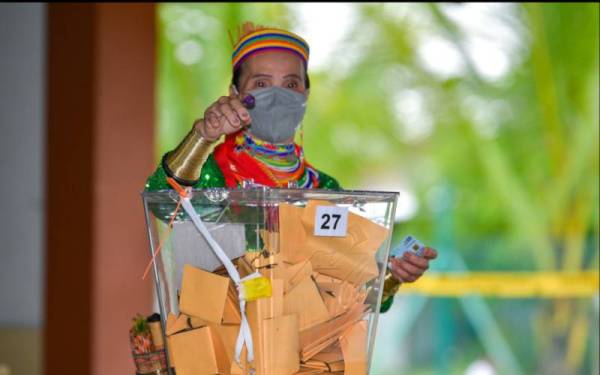 Singai Nekan, 69, wanita suku kaum Bidayuh Semban atau 'The Ring Ladies’ mengundi di Dewan Serbaguna Kampung Semban. - Foto Bernama