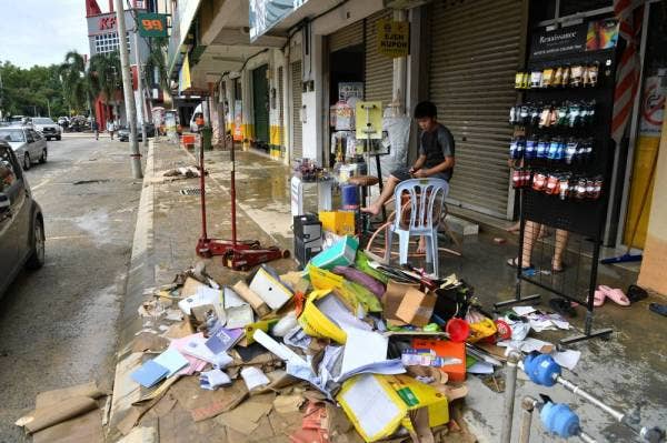 SEPANG, DEC 20 - Businesses cleaning up their flood affected shops in Dengkil, with some forced to throw away damaged items. (Source: Bernama)
