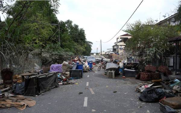 Keadaan jalan raya yang dipenuhi sampah dan barangan yang telah musnah akibat dilanda banjir ketika tinjauan di Taman Sri Muda Seksyen 25 Shah Alam pada Jumaat. - Foto Bernama 