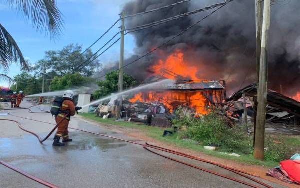 Anggota bomba melakukan operasi pemadaman di Jalan Bagan Pasir di sini pada Sabtu.