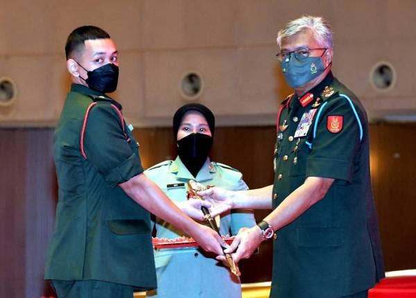 Zamrose (kanan) menyampaikan Anugerah Pegawai Kadet Palapes Terbaik kepada Leftenan Muda Hanif Fikri Peter daripada UMS pada majlis Lafaz Pengisytiharan Pentauliahan dan Pemakaian Pangkat Pegawai Kadet Palapes Darat Universiti Awam ke-39 bagi Zon Sarawak dan Sabah pada Sabtu. -FotoBernama