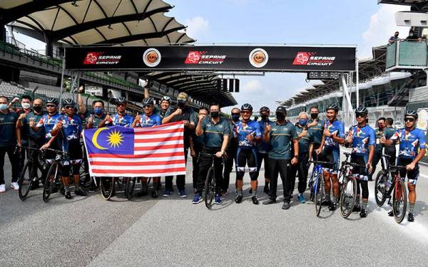 Mohd Zuki Ali (tengah) bergambar kenangan bersama lapan pelumba Maksak di Majlis Penutup dan Penyampaian Sijil Program Kayuhan Basikal Berkumpulan Paling Lama di Litar Antarabangsa Sepang pada Selasa. - Foto Bernama