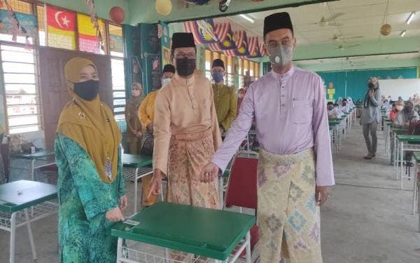 Saipolyazan (kanan) dan Salwana (kiri) menunjukkan meja murid yang disumbangkan oleh LZS di KAFA Integrasi Kampung RTB Bukit Changgang, Kuala Langat pada Jumaat.