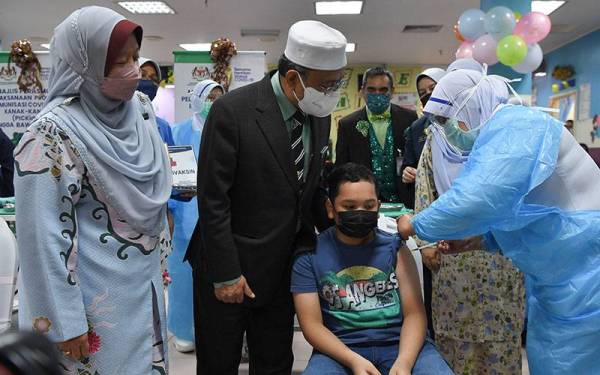 Pengerusi Jawatankuasa Kerajaan Tempatan, Perumahan, Kesihatan dan Alam Sekitar Terengganu, Dr Alias Razak (dua, kiri) meninjau proses suntikan vaksin kepada kanak-kanak menerusi Program Imunisasi Covid-19 Kanak-kanak (PICKids) peringkat negeri di Hospital Sultanah Nur Zahirah (HSNZ) hari ini.